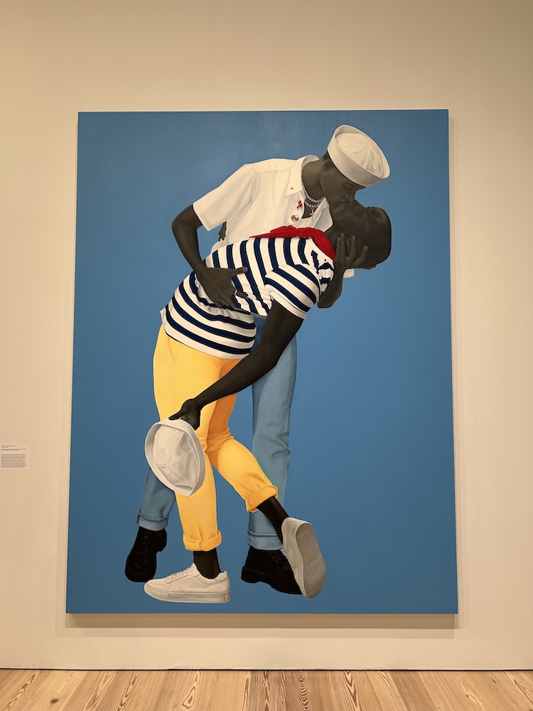 painting by Amy Sherald of two men in sailor clothing embracing in a kiss; one man cradles the other leaning back to receive the kiss