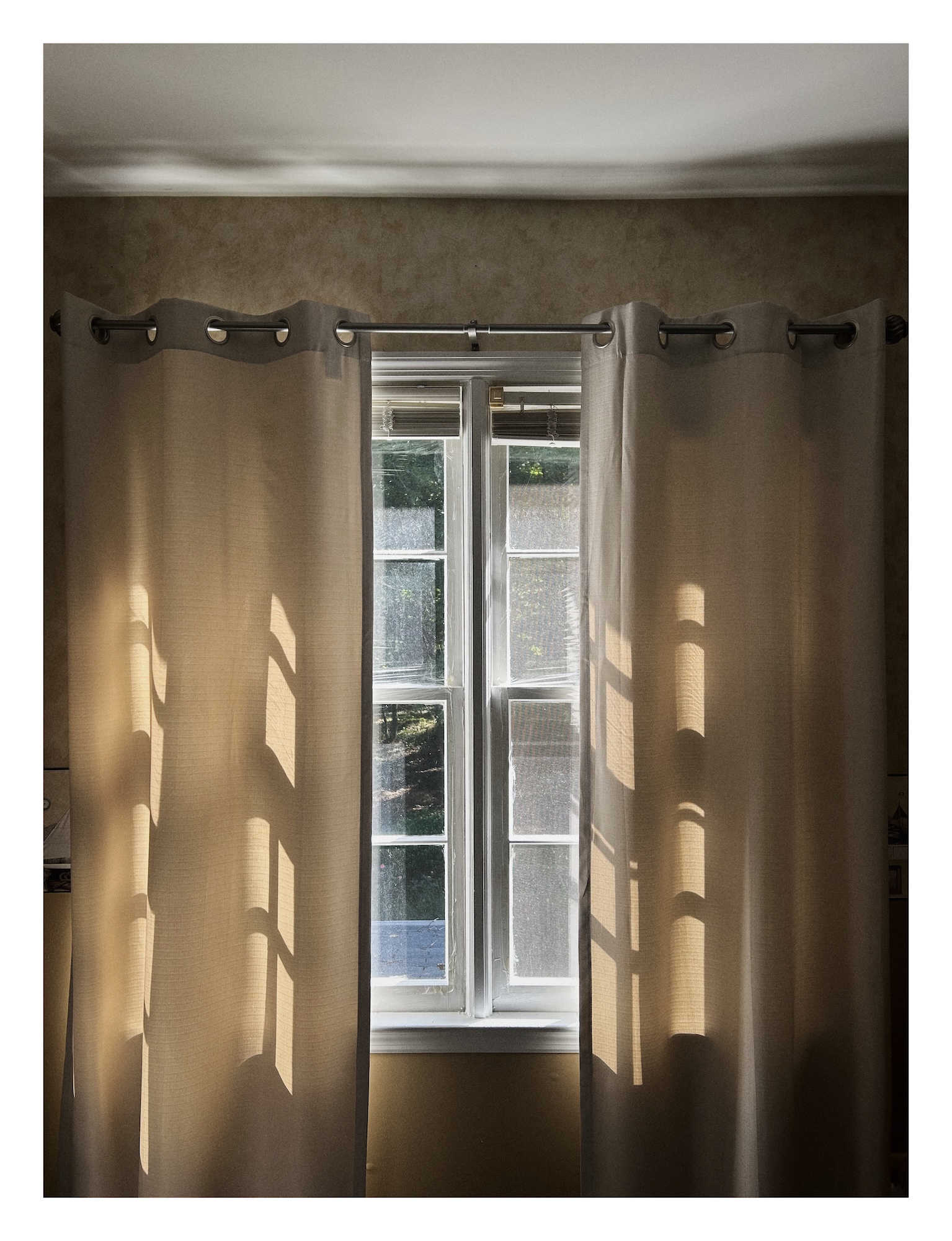 evening light comes in through pale beige curtains in a quiet room