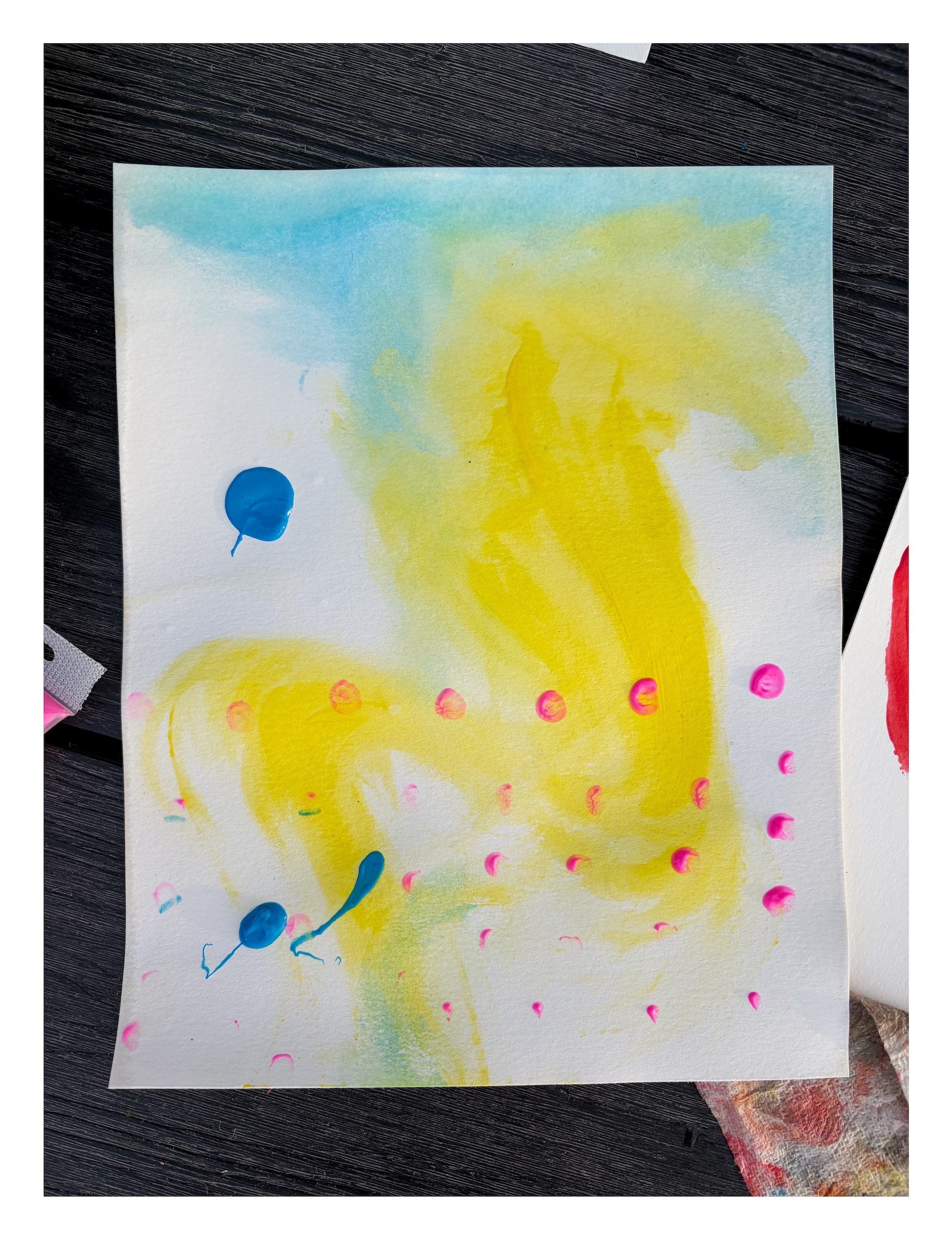 abstract fingerpainting in yellow blue and pink